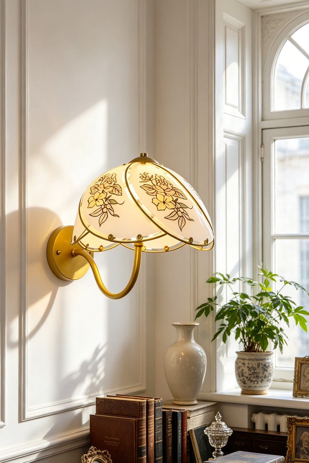 Lillian Retro Floral Wall Lamp | Glass, Metal | Mounted next to a bright window over a wooden writing desk with books in a classic home study | Samu Lamp