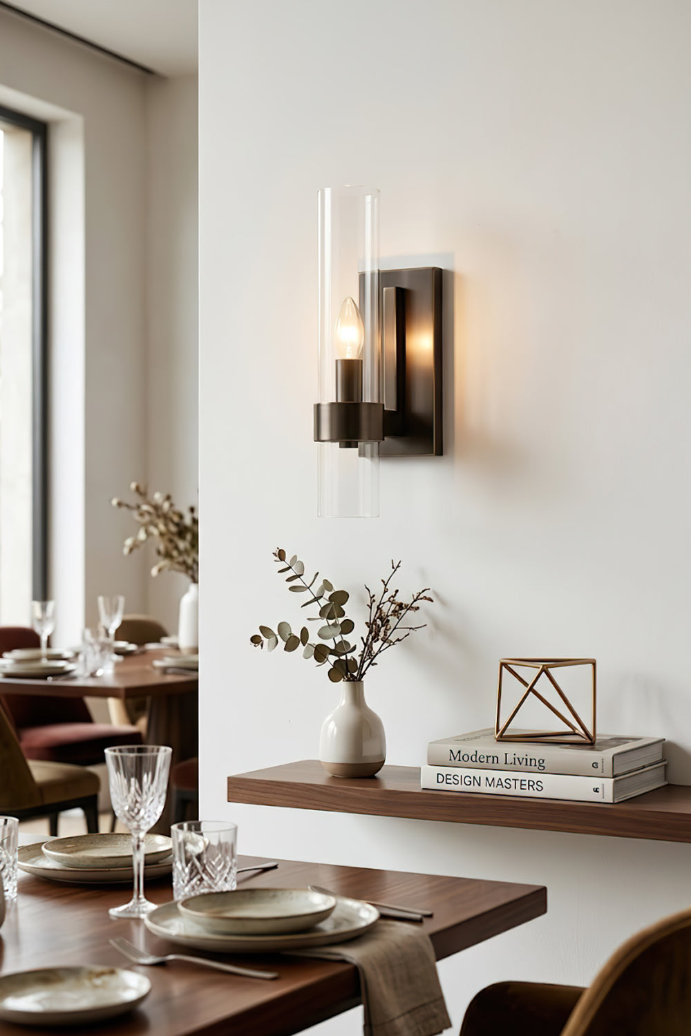 Sleek linear wall sconce in black finish | Brass, Glass | Dining room scene near a wooden table | Samu Lamp
