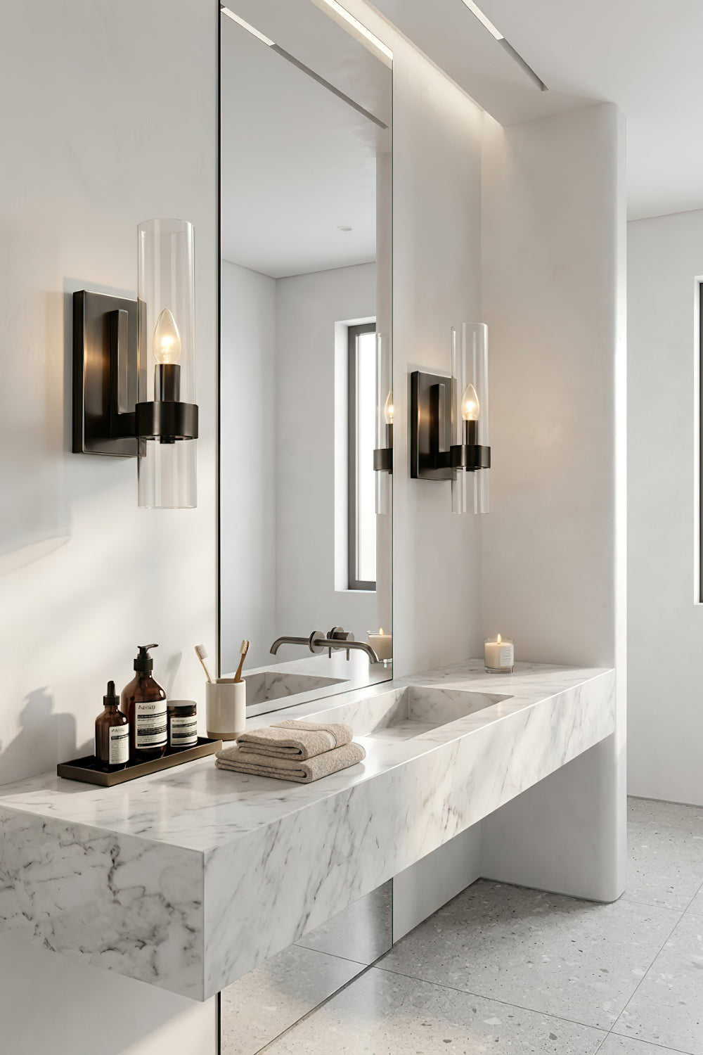 Pair of black linear glass wall sconces | Brass, Glass | Flanking a bathroom mirror over a marble counter | Samu Lamp