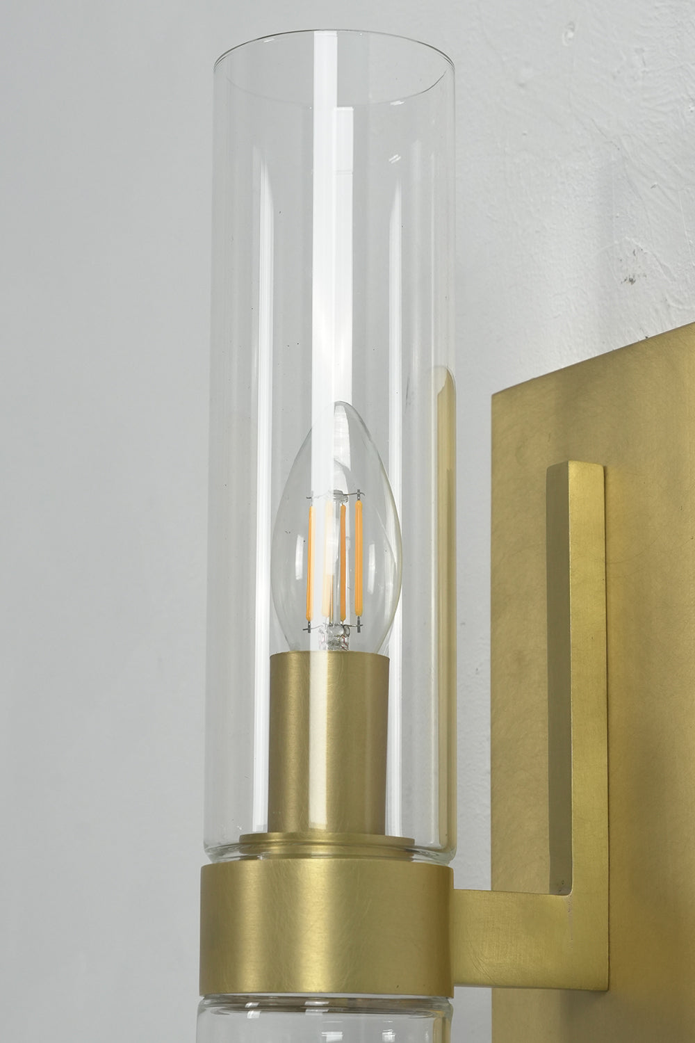 Detailed view of clear glass cylinder and bulb | Brass, Glass | Focus on the transparent material and light source | Samu Lamp