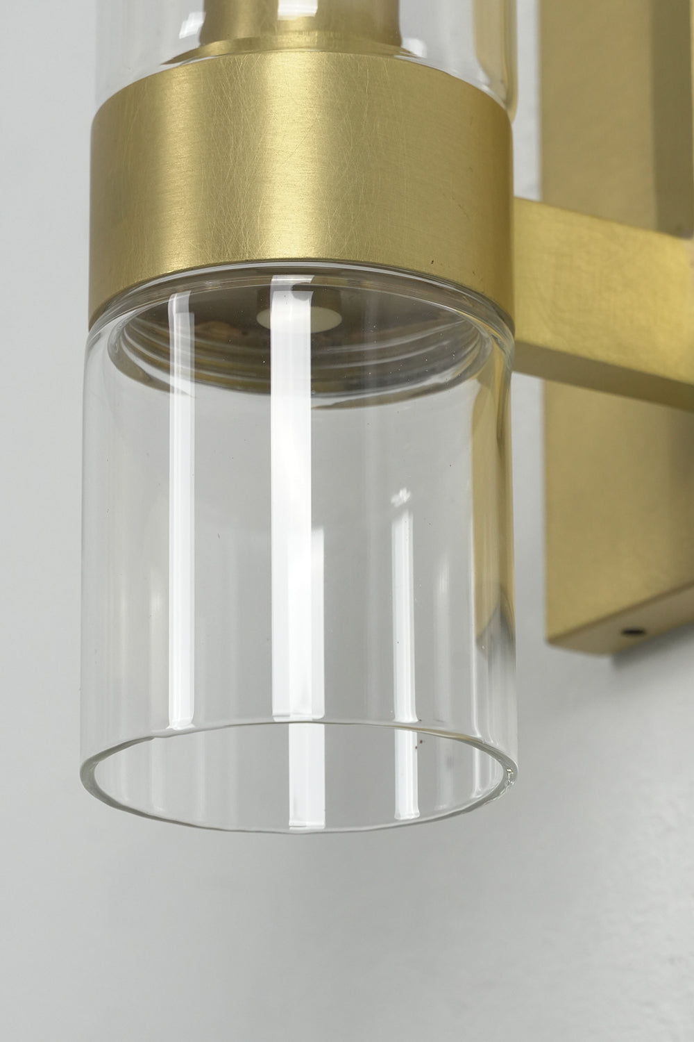 Extreme close-up of the brass ring support | Brass | Showing the polished metal finish and glass connection | Samu Lamp