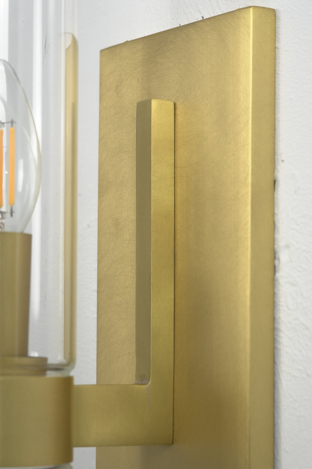 Side bracket and backplate detail | Brass | Close-up showing the metallic texture and installation point | Samu Lamp
