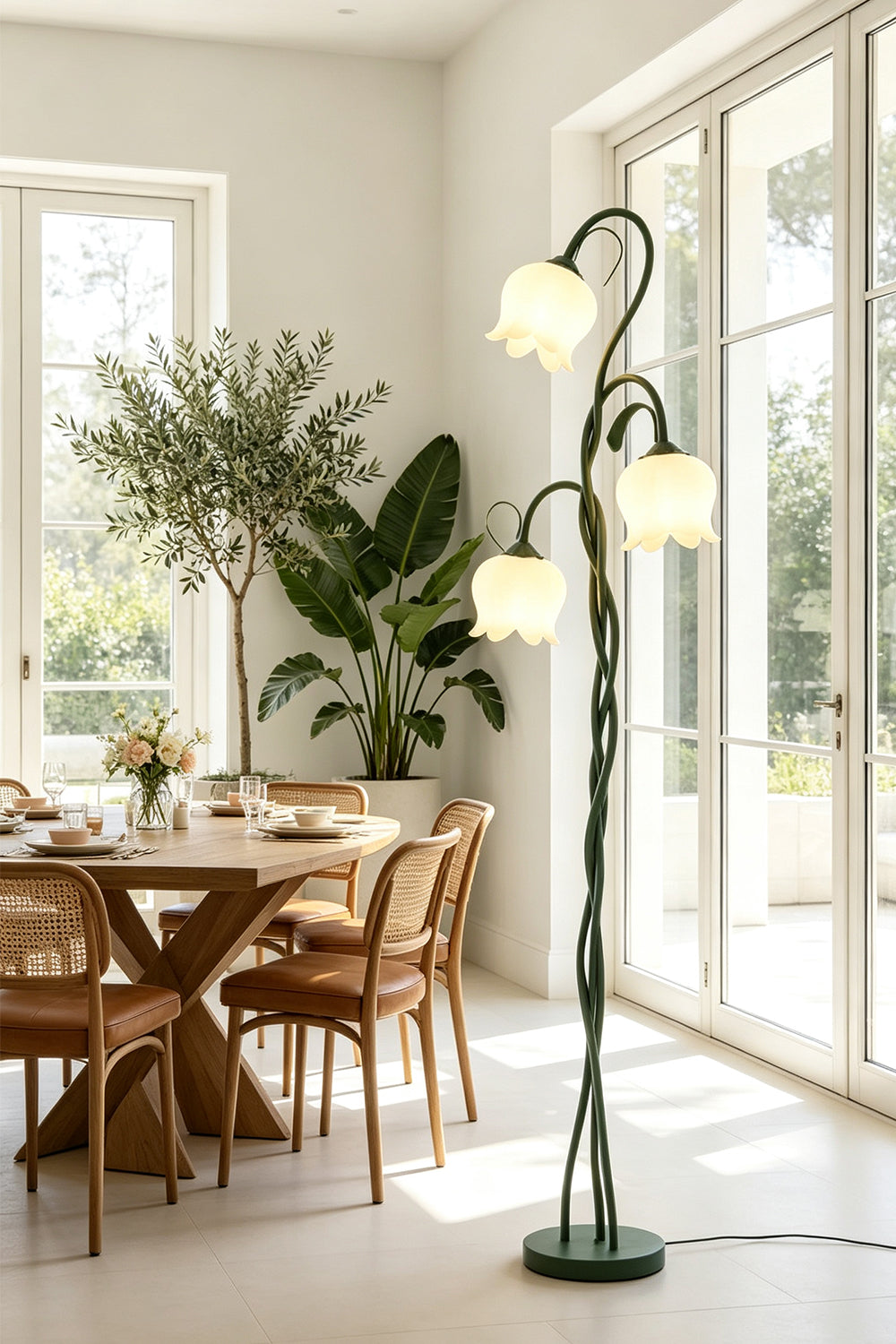 Linnea Tulip Bloom Floor Lamp | Glass and Green Metal | Illuminating a dining area featuring wooden furniture and large indoor plants | Samu Lamp