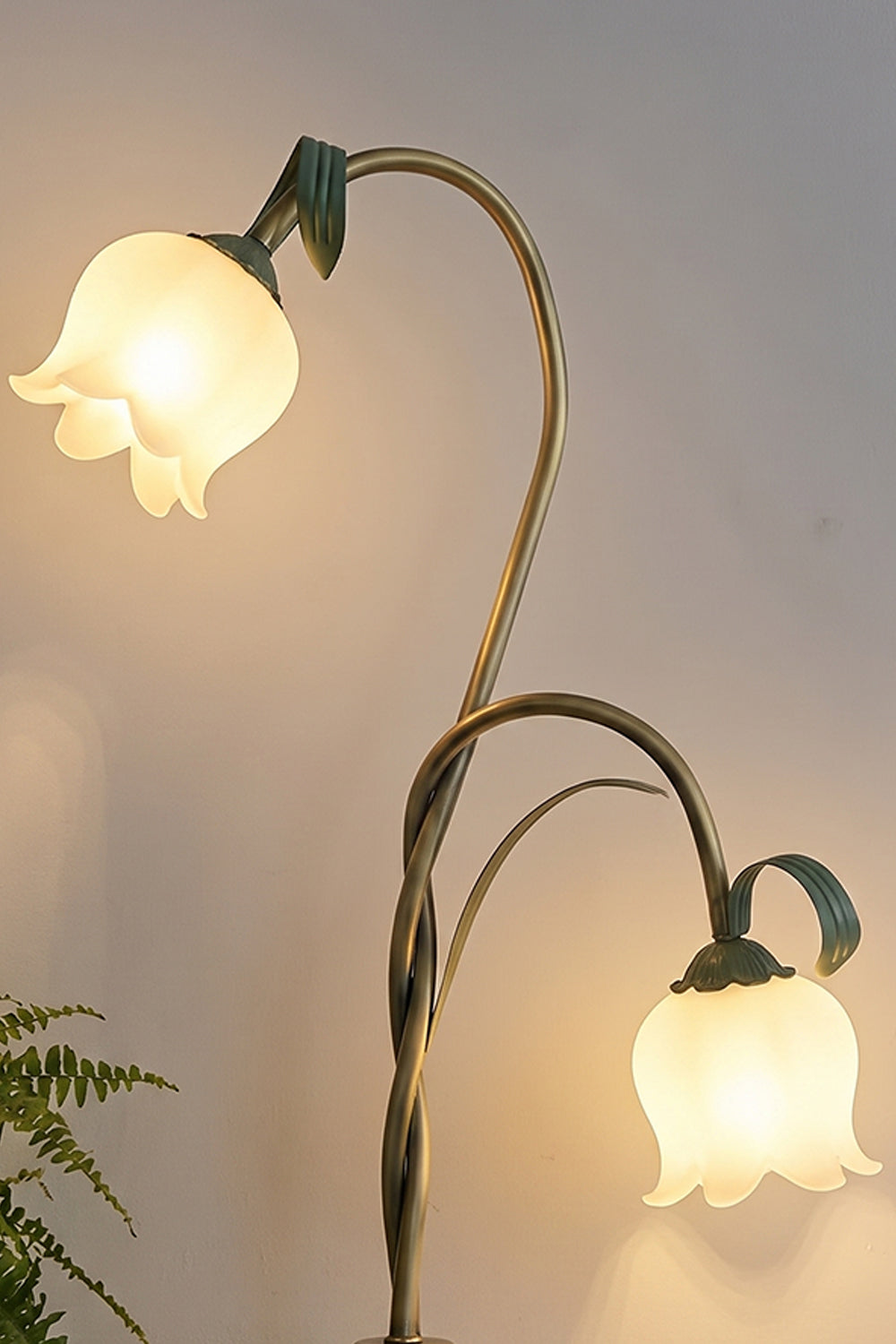 Linnea Tulip Bloom Floor Lamp | Glass and Green Metal | Medium close-up highlighting illuminated flower shades on intertwined green branches | Samu Lamp