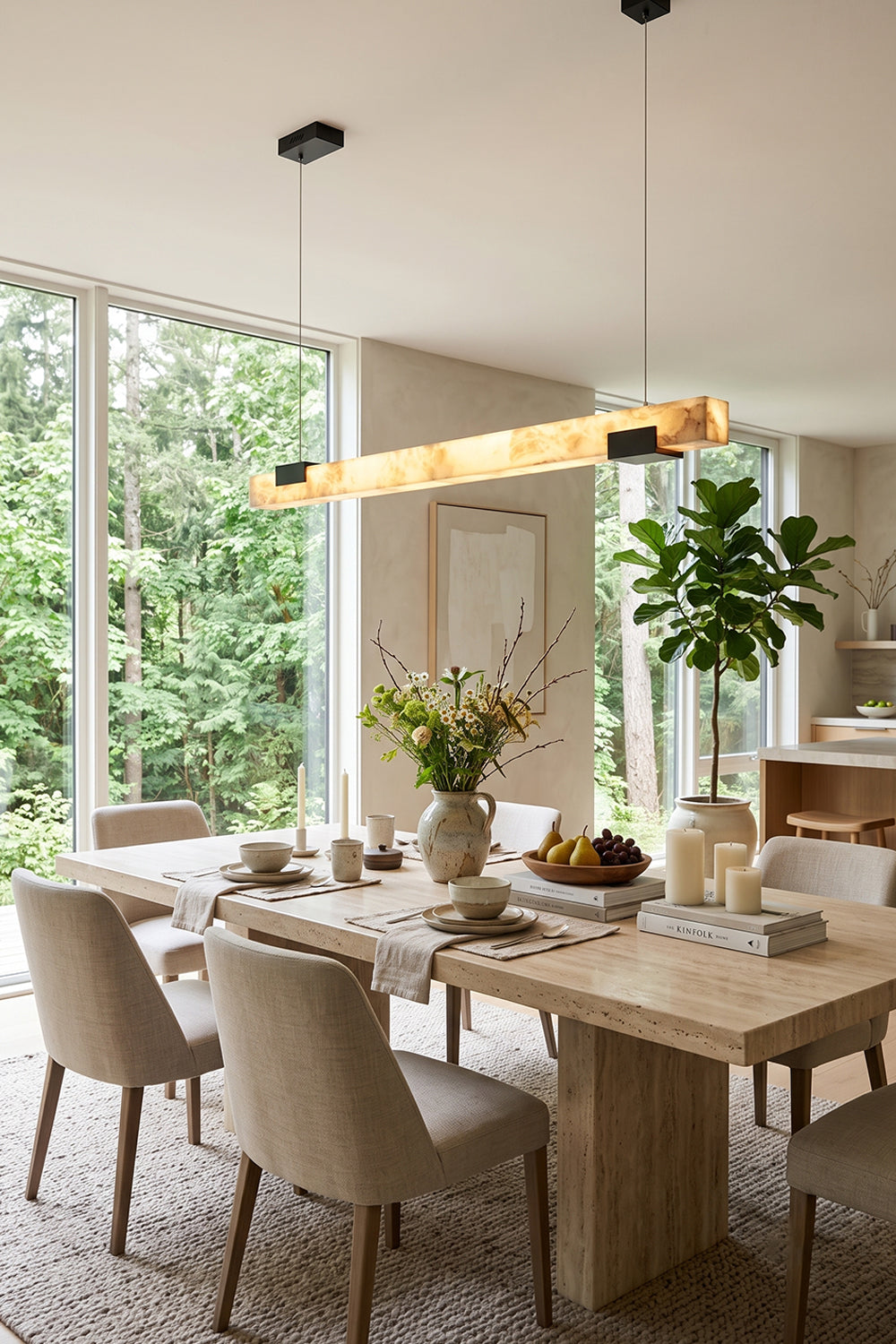 Liora Linear Alabaster Pendant Light | Natural Alabaster and Black Metal | Styled in a bright modern dining room above a long wooden table with beige fabric chairs | Samu Lamp