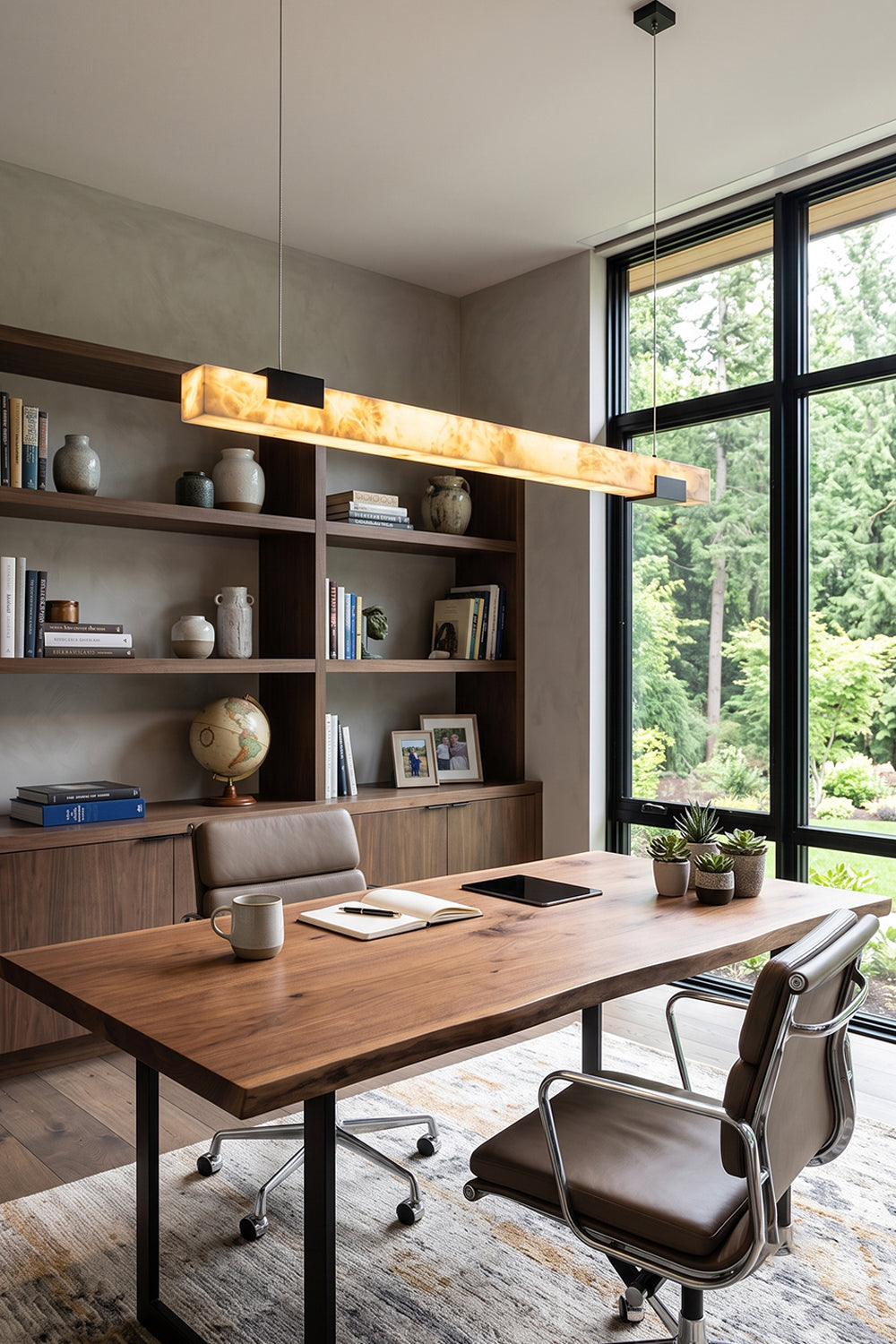Liora Linear Alabaster Pendant Light | Natural Alabaster and Black Metal | Hanging above a long wooden desk with an office chair in a bright contemporary study room | Samu Lamp