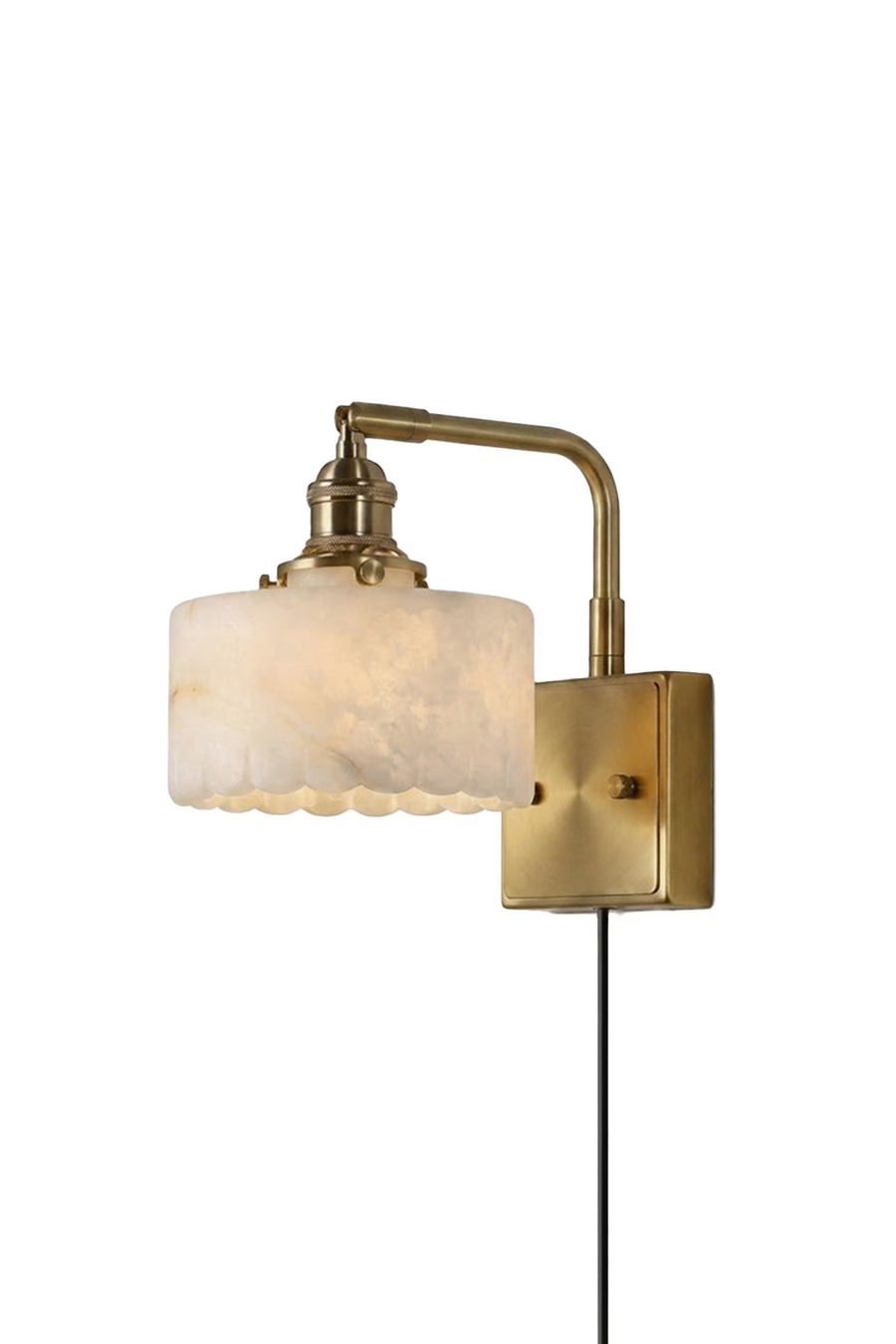 Liora Scalloped Alabaster Wall Sconce | Natural Alabaster and Brushed Brass | Full studio front shot on a white background showing the curved brass arm, plug-in cord, and lit scalloped stone shade | Samu Lamp