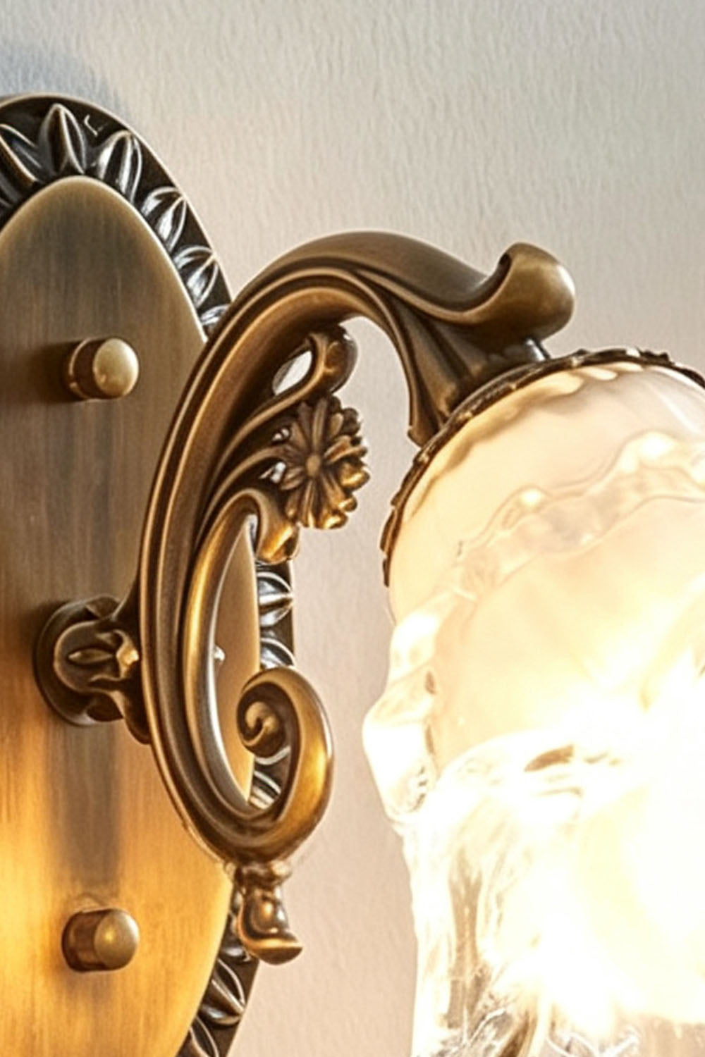Lisette Blossom Glass Brass Wall Lamp | Glass and Brass | Close-up detail of the ornate carved brass scroll arm and glass shade holder | Samu Lamp