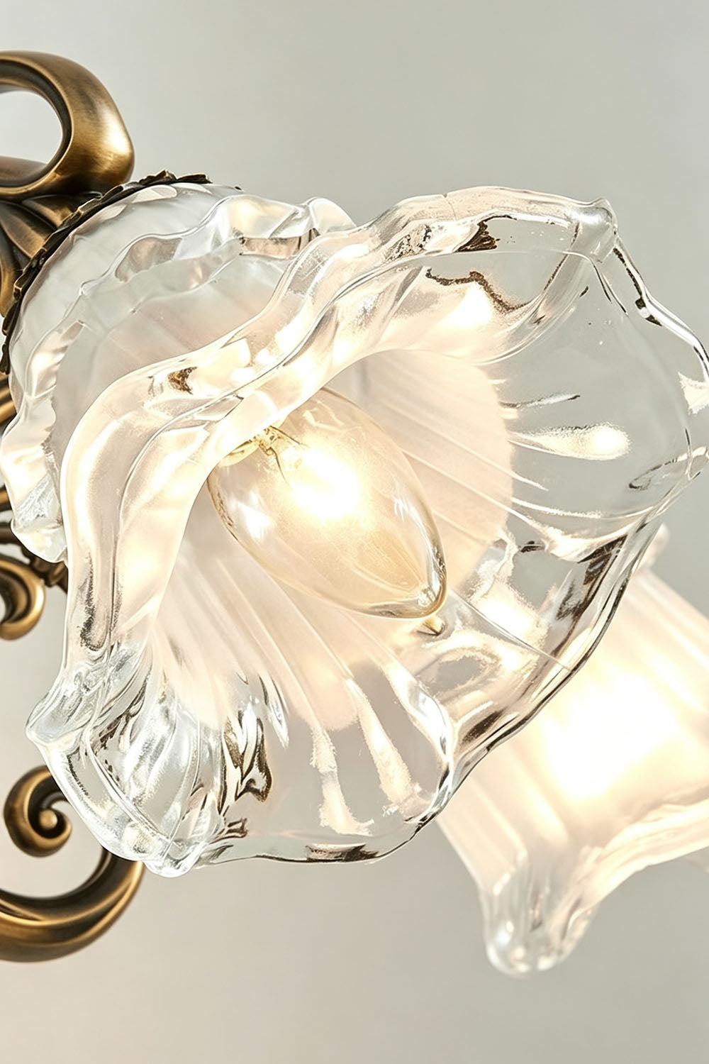 Lisette Blossom Glass Brass Wall Lamp | Glass and Brass | Close-up view highlighting the flower blossom glass shade with ruffled edges | Samu Lamp