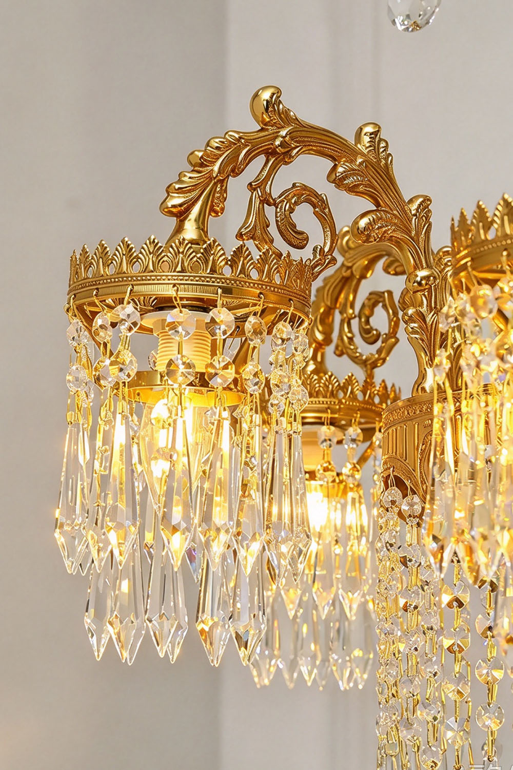 Lisonne Brass Crystal Fringe Linear Chandelier | Cut Crystal and Brass | Detail shot highlighting intricate carved brass scrollwork and crown rim | Samu Lamp
