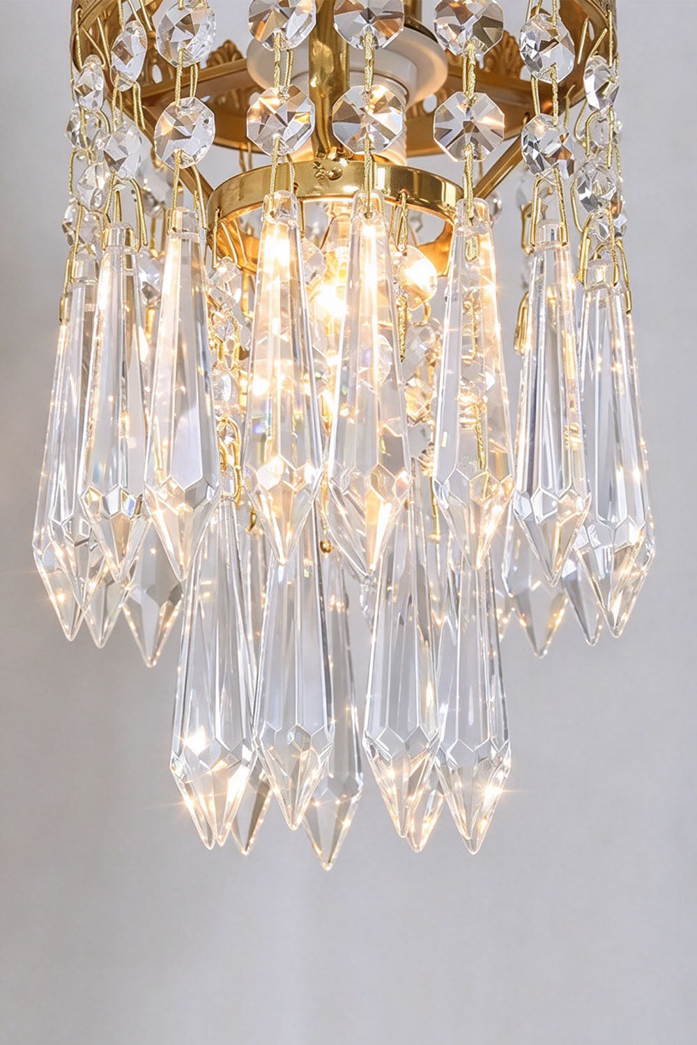 Lisonne Brass Crystal Fringe Linear Chandelier | Cut Crystal and Brass | Close-up view of the glowing crystal prism fringe emitting warm light | Samu Lamp