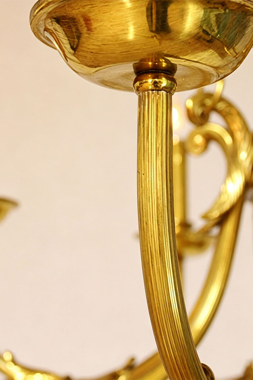 Close-up of Lucienne Fluted Glass Urn Brass Chandelier showcasing its elegant brass detailing.