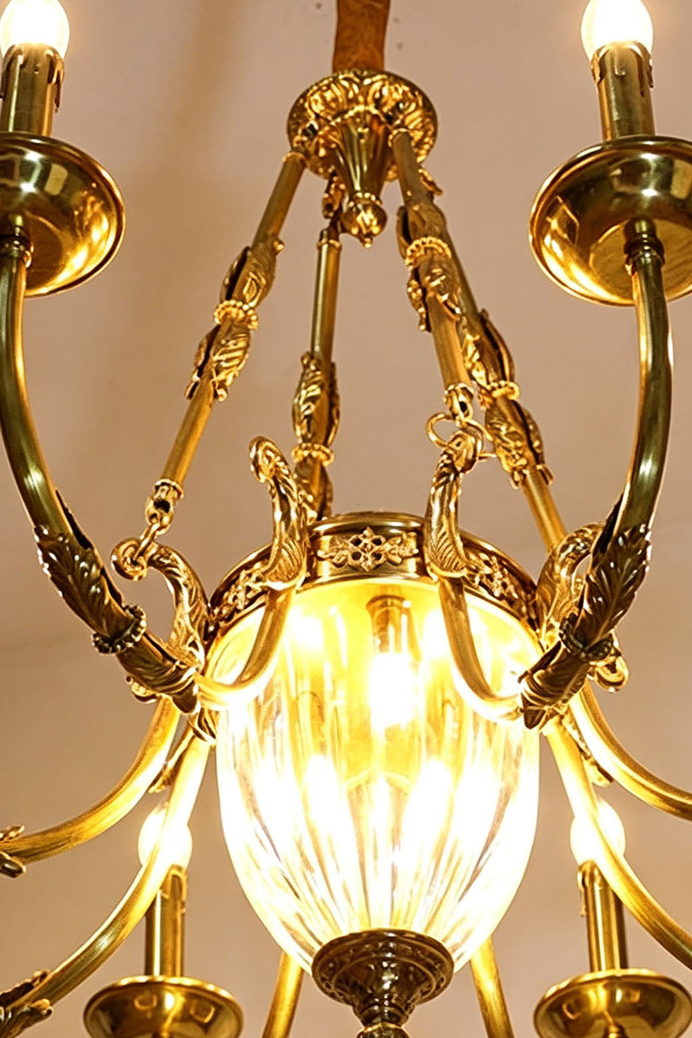 Lucienne Fluted Glass Urn Brass Chandelier illuminated with warm light.