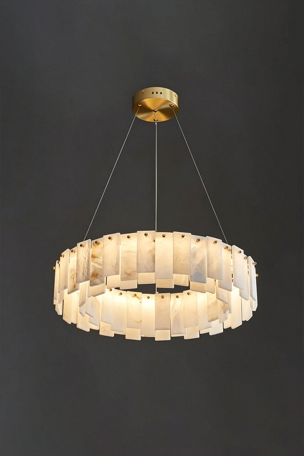 Luminous Alabaster Halcyon Chandelier | Alabaster, Brass | Lit single-tier chandelier on dark grey background | Samu Lamp