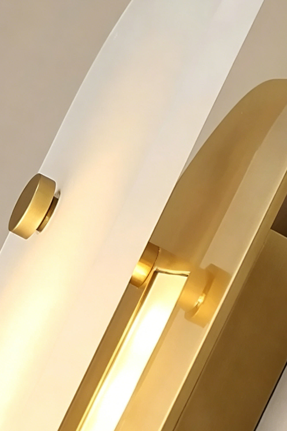 Edge profile of alabaster lamp | Alabaster, Metal | Stone against large brass panel detail | Samu Lamp