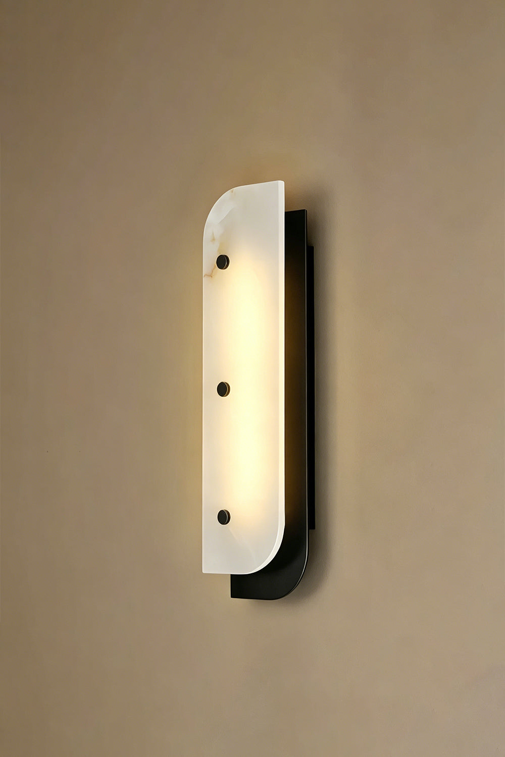 Lit alabaster wall sconce | Alabaster, Metal | Illuminated view against plain wall | Samu Lamp