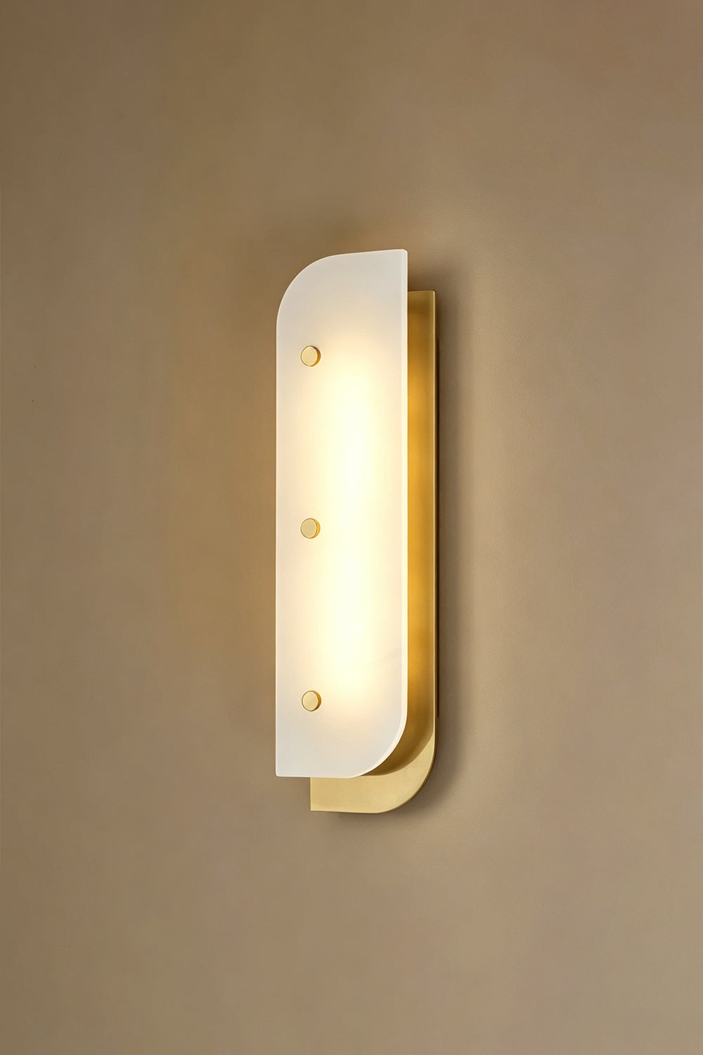 Lit alabaster wall sconce | Alabaster, Metal | Angle perspective against plain wall | Samu Lamp