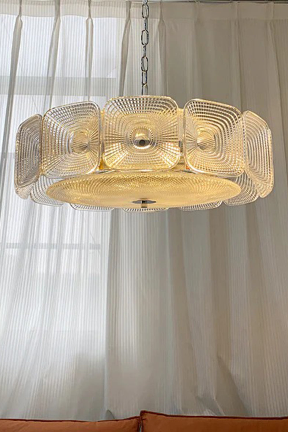 Lyra Geometric Glass Chandelier | Glass, Metal | Hanging elegantly in front of a tall window with translucent white linen curtains, radiating a cozy amber light | Samu Lamp