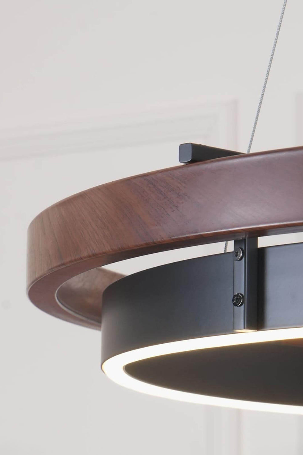 Close-up of the Lysander Dual-Ring LED Chandelier showcasing a walnut finish and matte black accents.