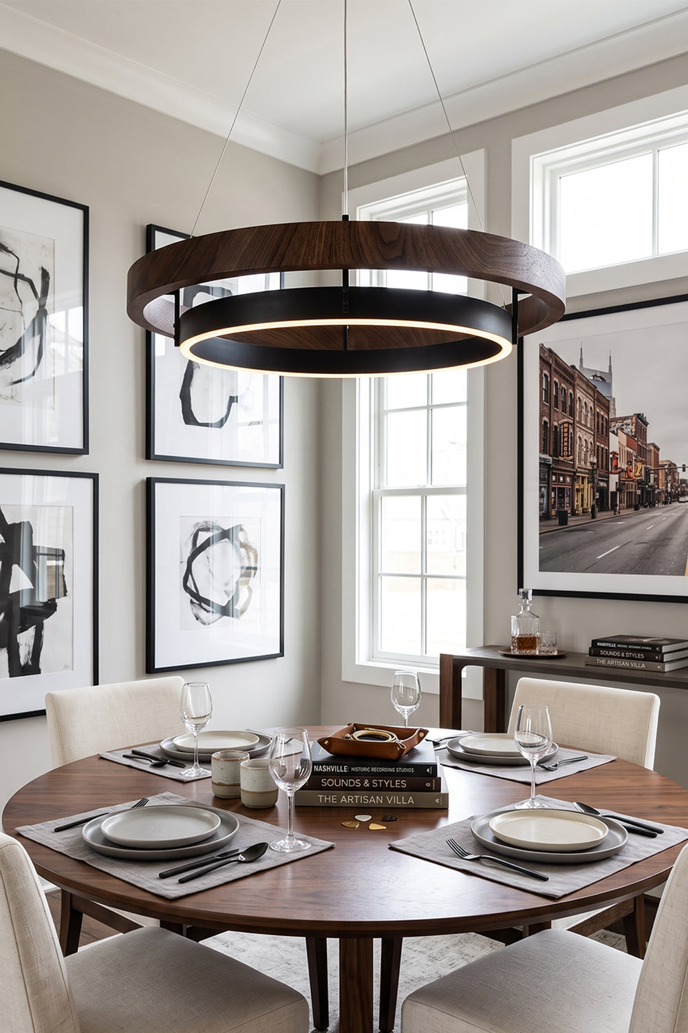 Lysander Dual-Ring LED Chandelier hanging above a modern dining table, illuminating a stylish dining space.