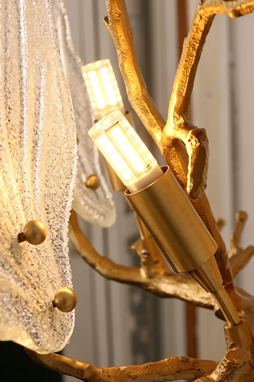 Magnolia Arbor Brass Wall Lamp | Brass, Glass | Detailed view revealing the internal gold cylindrical bulb sockets behind the textured glass elements | Detail shot | Samu Lamp