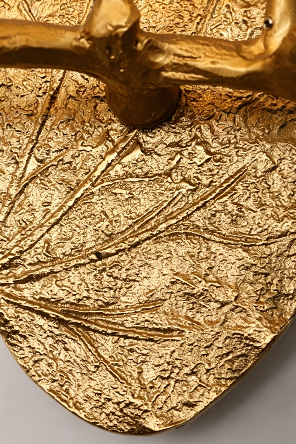 Magnolia Arbor Brass Wall Lamp | Brass, Glass | Macro shot showcasing the heavy botanical leaf veins and bark texture of the gold oval backplate | Detail shot | Samu Lamp