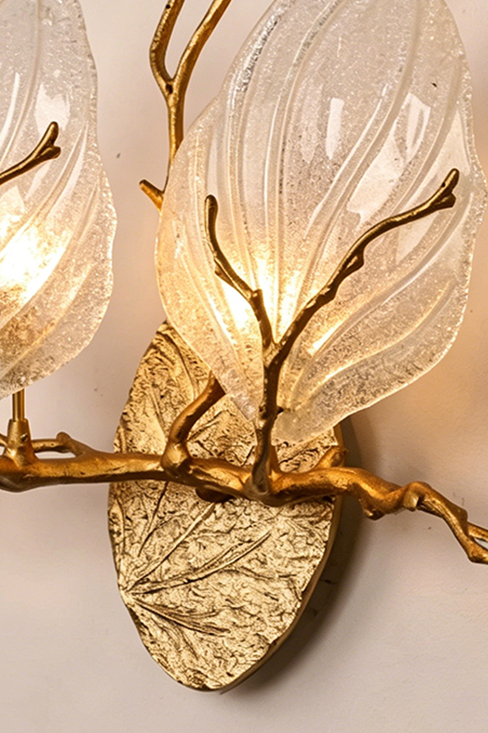 Magnolia Arbor Brass Wall Lamp | Brass, Glass | Close-up showing both glowing glass shades and the intersection of the organic brass branches on the base | Detail shot | Samu Lamp