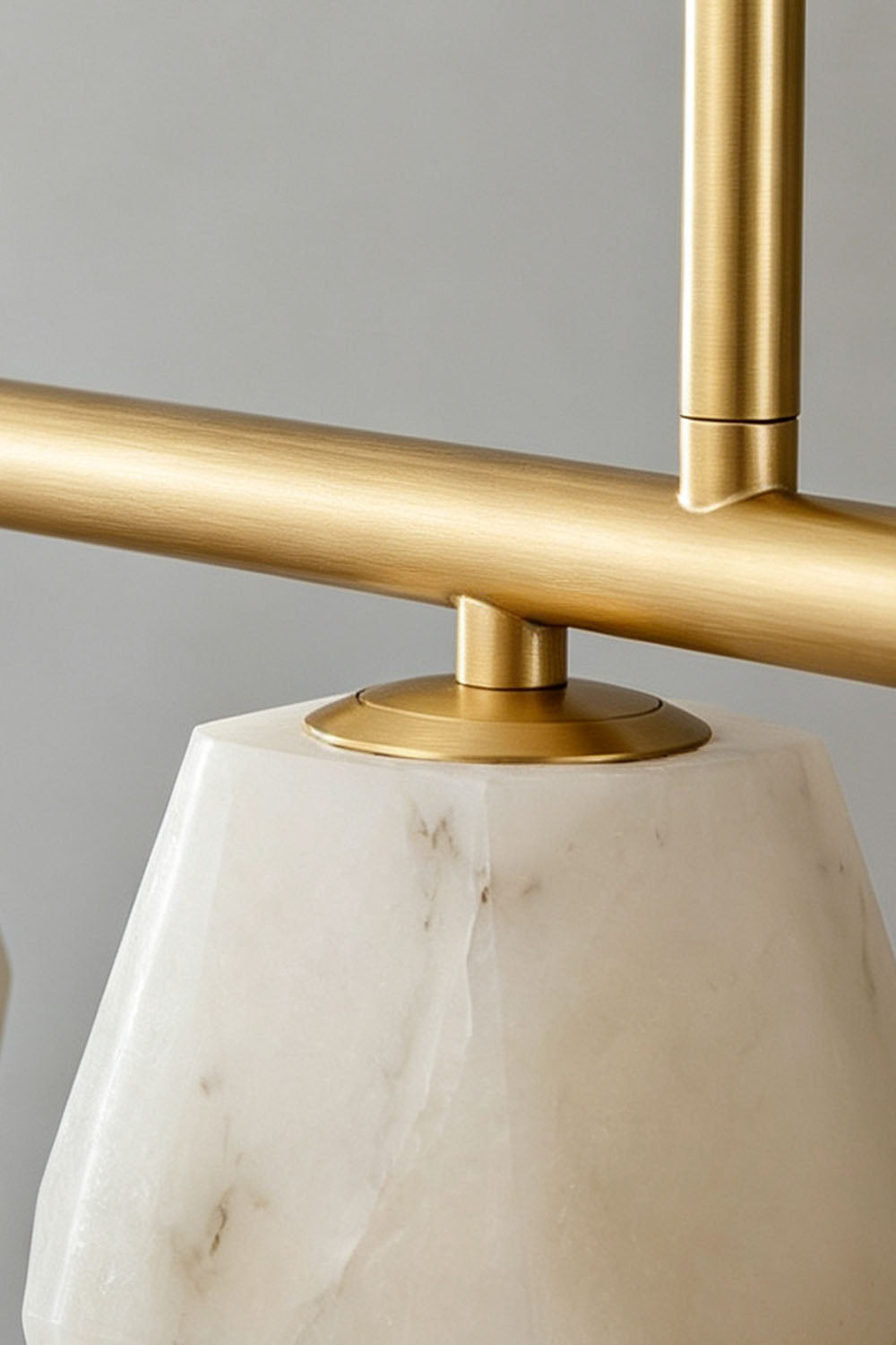 Manon Alabaster Drop Linear Chandelier | Natural Alabaster and Brass | Close-up view of the brass linear frame and alabaster shade connection | Samu Lamp