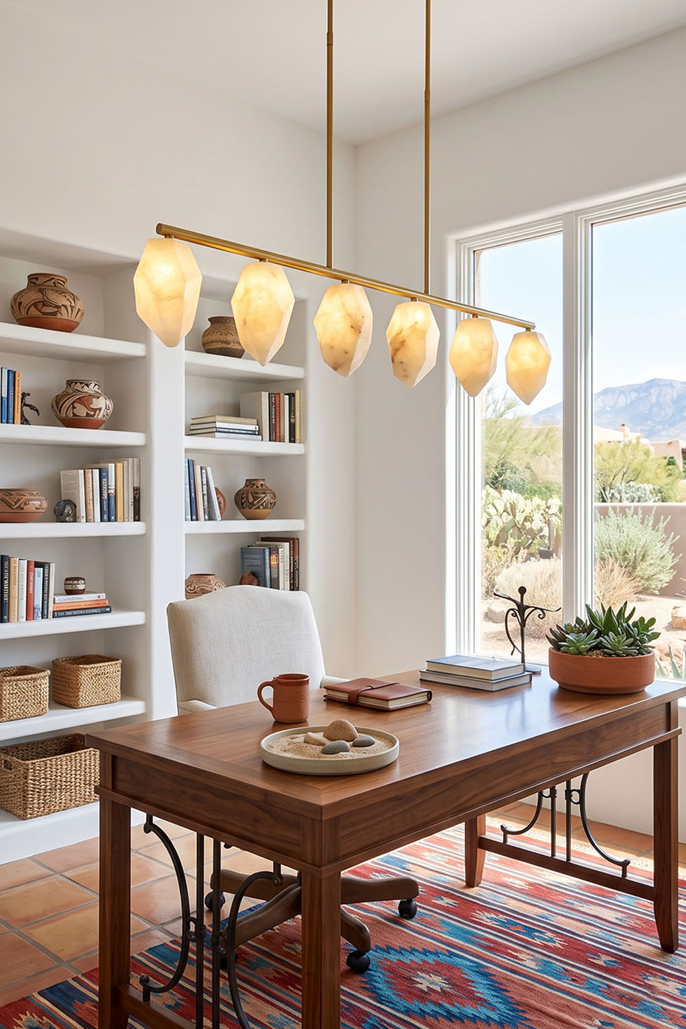 Manon Alabaster Drop Linear Chandelier | Natural Alabaster and Brass | Displayed in a home office over a wooden desk with a large bookshelf | Samu Lamp