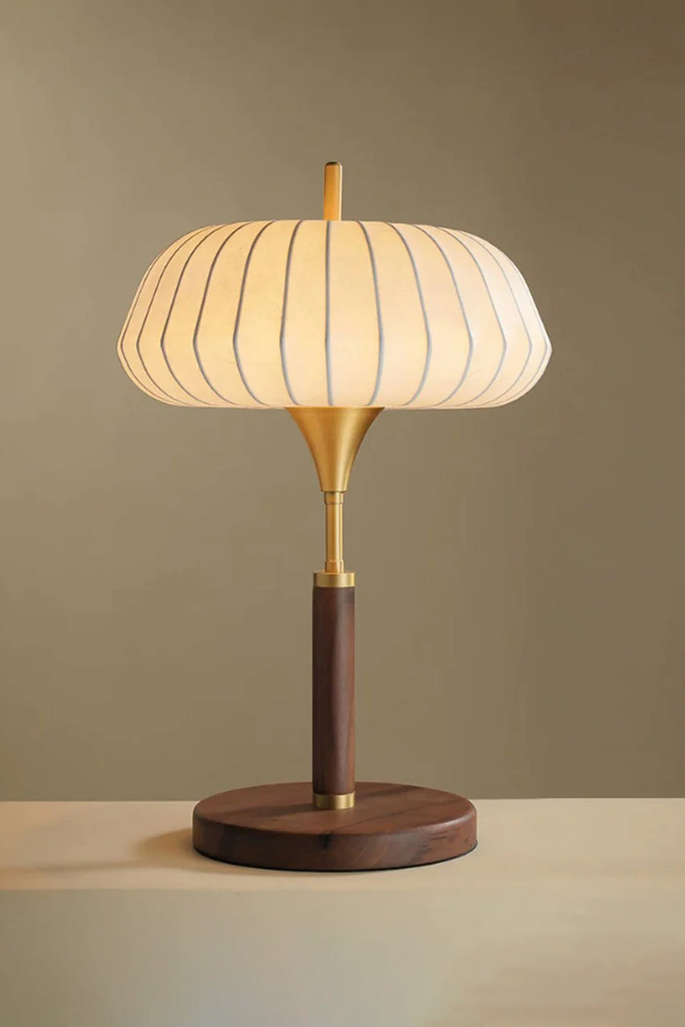 Maren Woven Silk Gourd Table Lamp | Woven Silk, Brass and Wood | Warm ambient front view highlighting the glowing silk shade | Samu Lamp