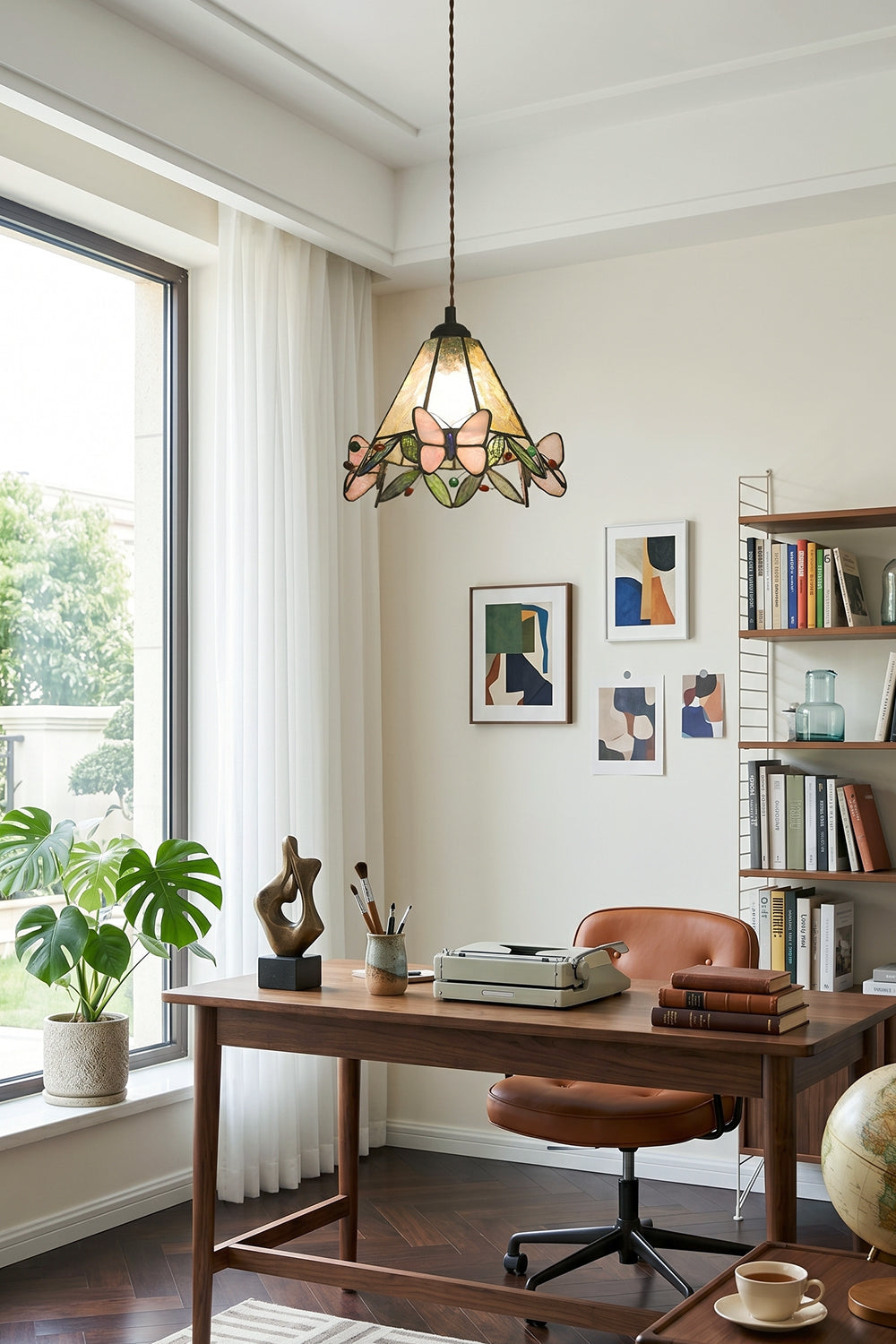 Mariposa Canopy Stained Glass Pendant Lamp | Glass, Metal | Installed in a cozy home office workspace above a wooden writing desk and leather chair | Samu Lamp