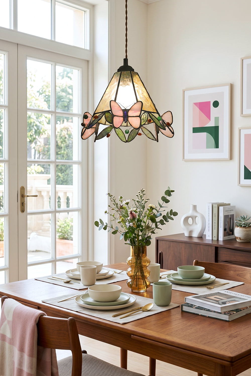 Mariposa Canopy Stained Glass Pendant Lamp | Glass, Metal | Single pendant light hanging over a wooden dining table decorated with green plants and tableware in a bright room | Samu Lamp