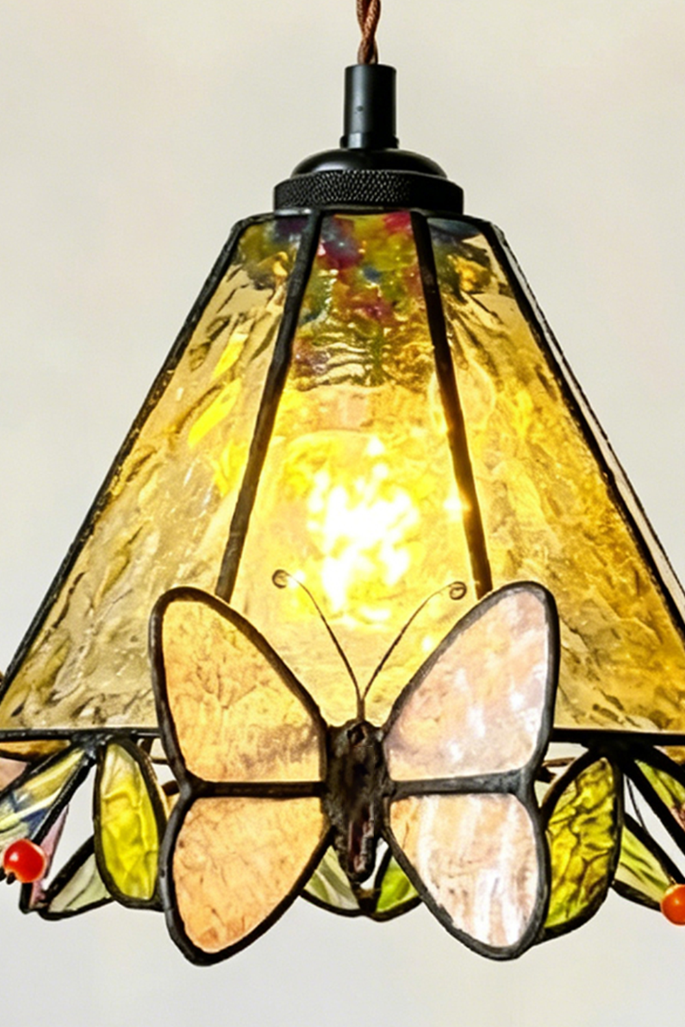 Mariposa Canopy Stained Glass Pendant Lamp | Glass, Metal | Frontal close-up of the fully lit stained glass shade showing the black canopy hardware attachment | Detail shot | Samu Lamp