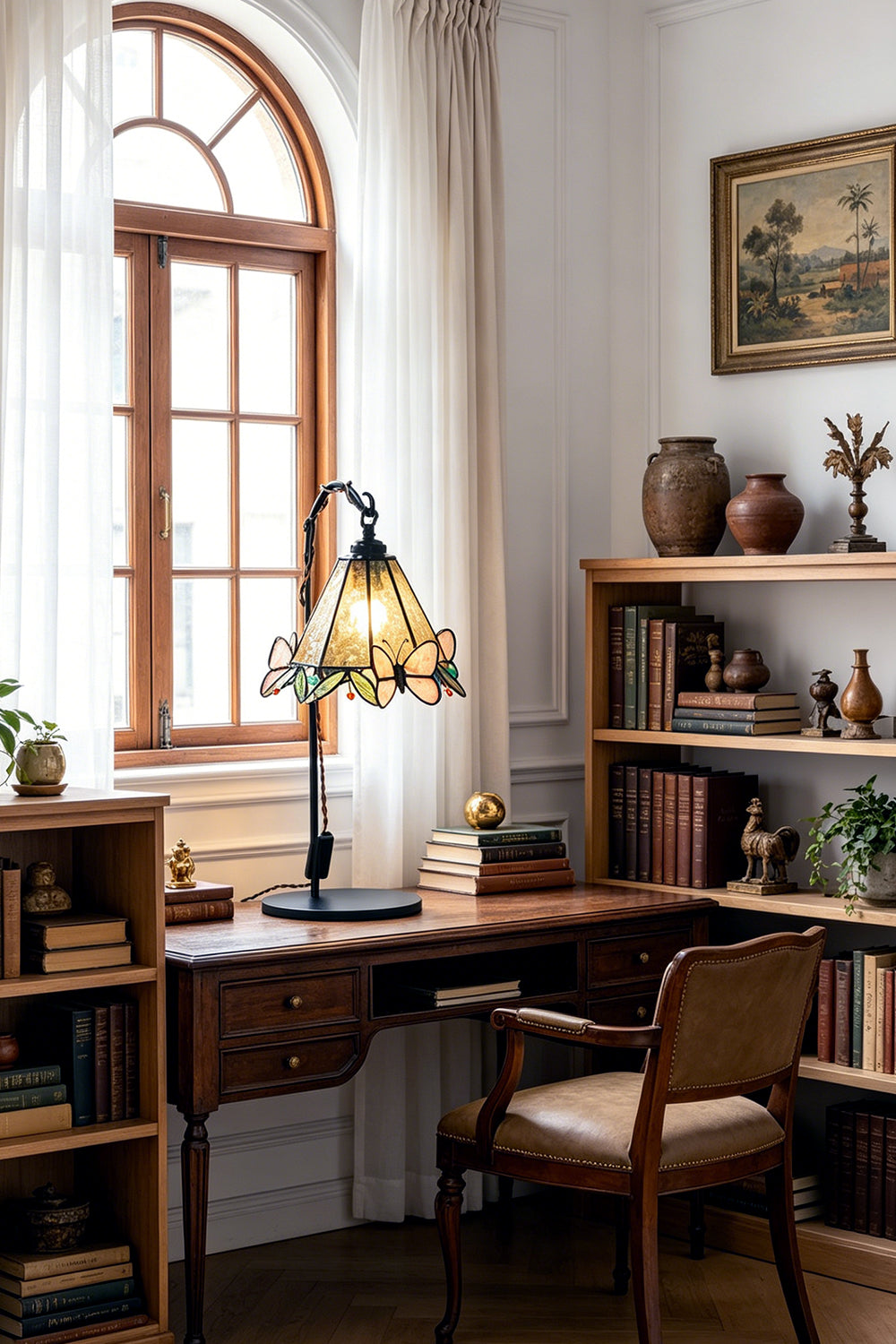 Mariposa Stained Glass Table Lamp | Glass, Metal | Illuminating a corner study workspace next to built-in wooden bookshelves and a large window | Samu Lamp