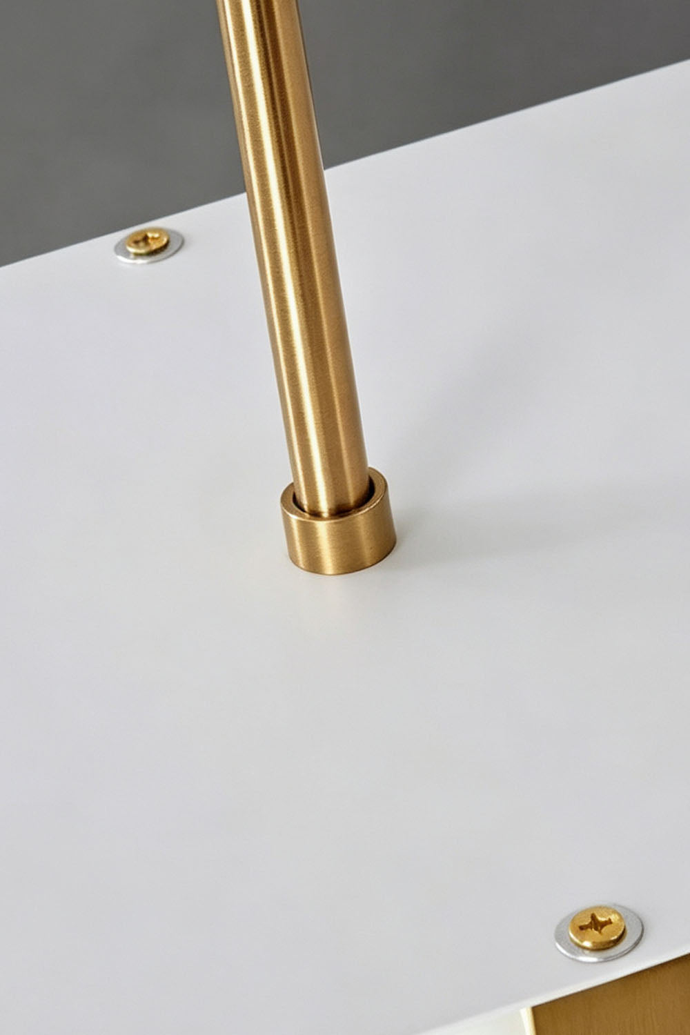 Close-up of Marlen Alabaster Bar Linear Pendant Light's brass accent and white surface.
