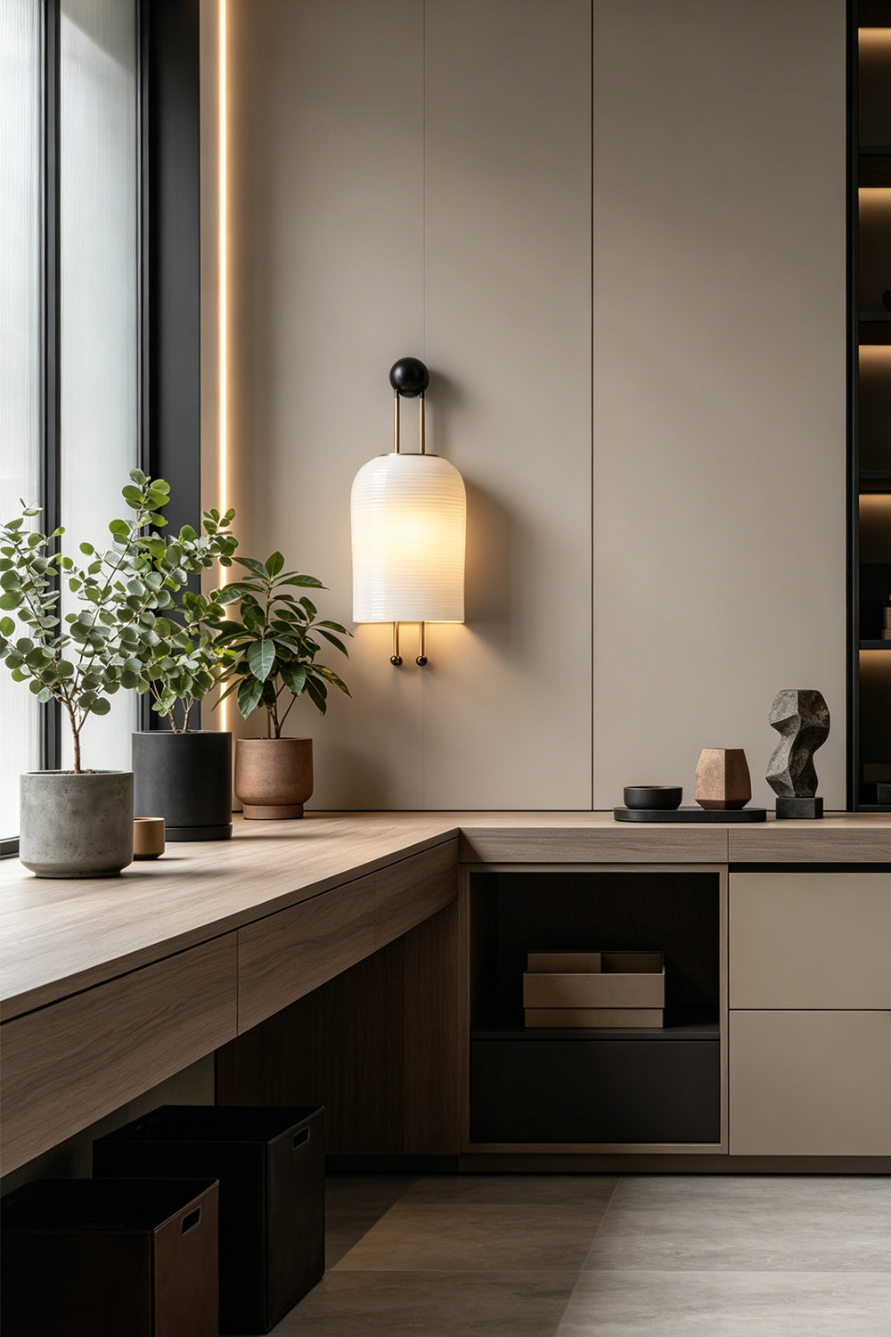 Marlow Linear Ribbed Glass Wall Lamp | Glass, Metal | Installed as a sleek wall sconce above a long minimalist wooden counter in a modern kitchen area | Samu Lamp