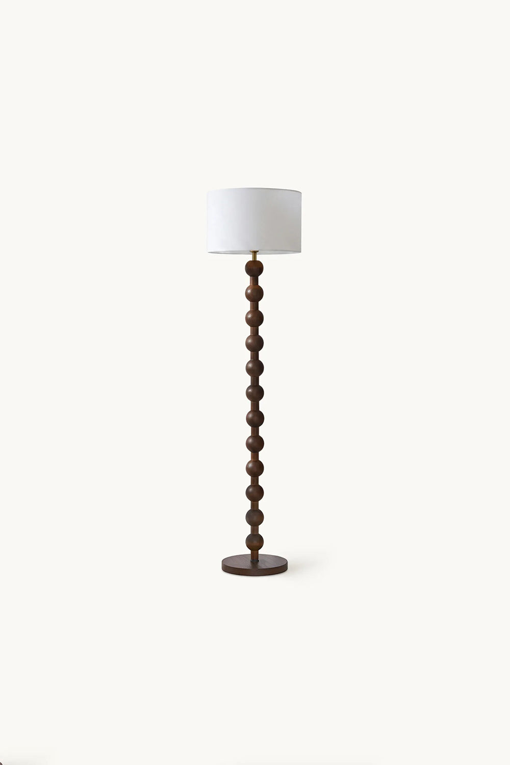 Marlow Stacked Wood Floor Lamp | Wood, Fabric | Studio full-length shot of the unlit dark wood bobbin floor lamp against a plain light beige background | Samu Lamp