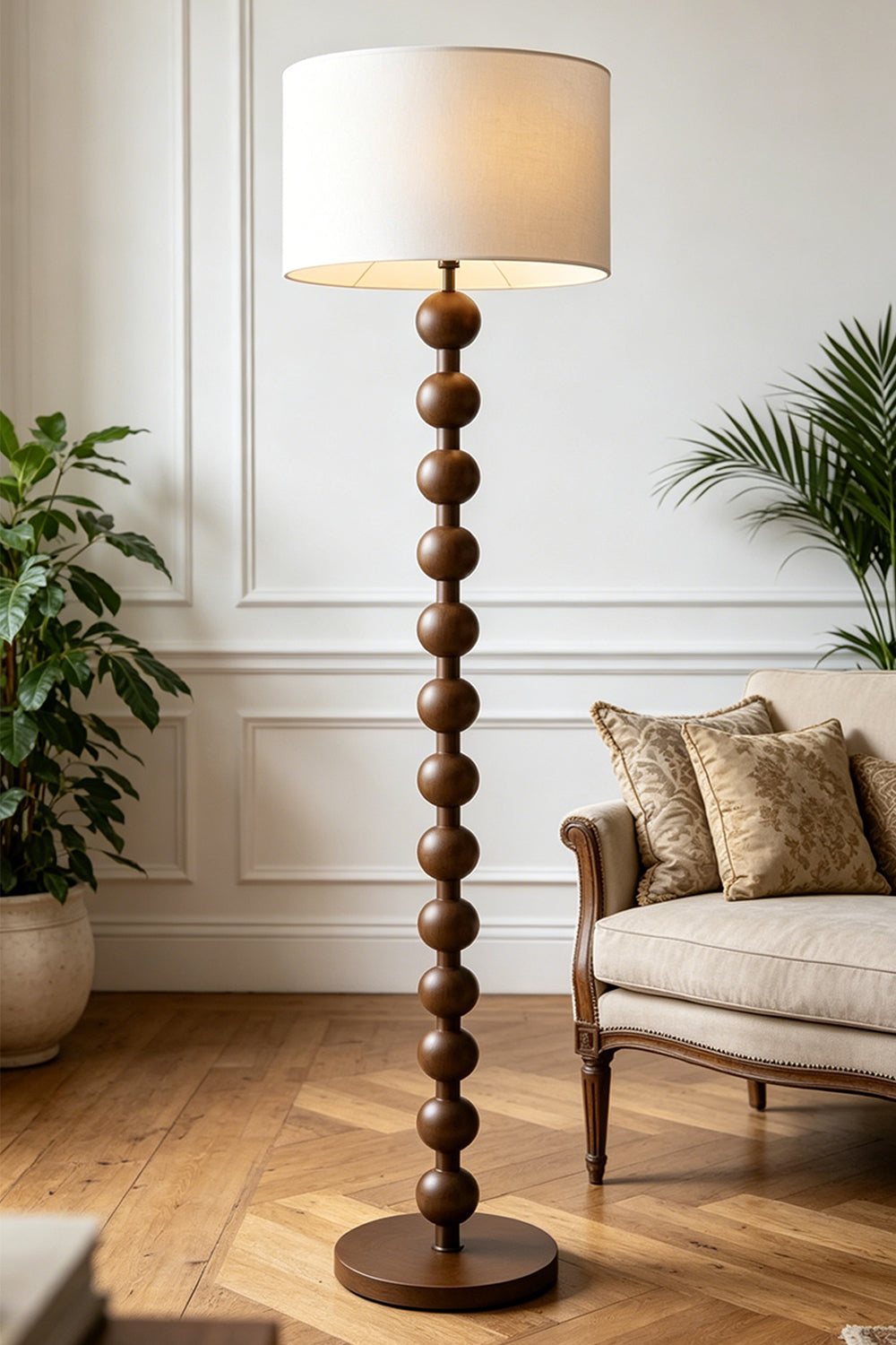 Marlow Stacked Wood Floor Lamp | Wood, Fabric | Placed in a cozy living room nook, providing soft ambient lighting next to a cream armchair on a classic herringbone wood floor | Samu Lamp