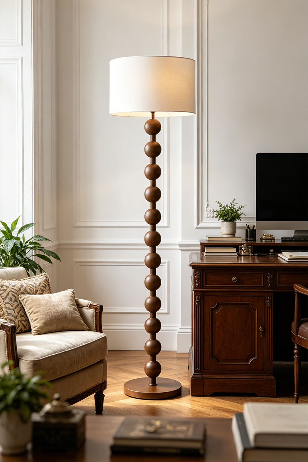 Marlow Stacked Wood Floor Lamp | Wood, Fabric | Positioned as an elegant reading light in a home office or study room near a dark wood desk and upholstered seating | Samu Lamp