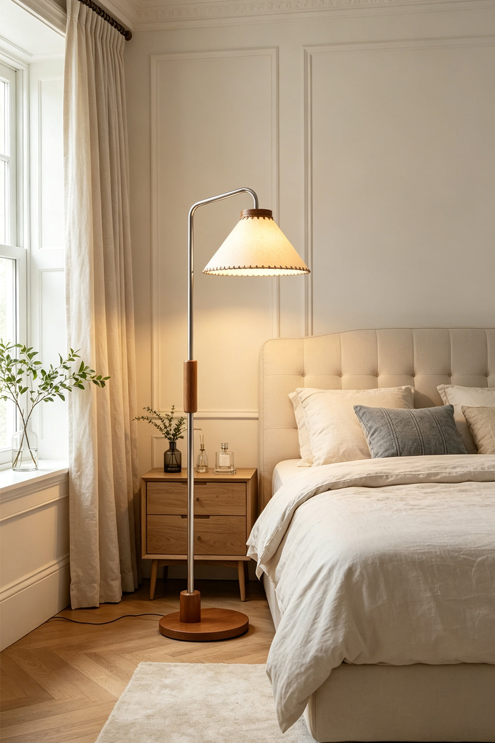 Marlowe Angled Linen Reading Floor Lamp | Linen, Wood, and Chrome Metal | Standing in a cozy bedroom beside a cream tufted bed and a wooden nightstand by the window | Samu Lamp