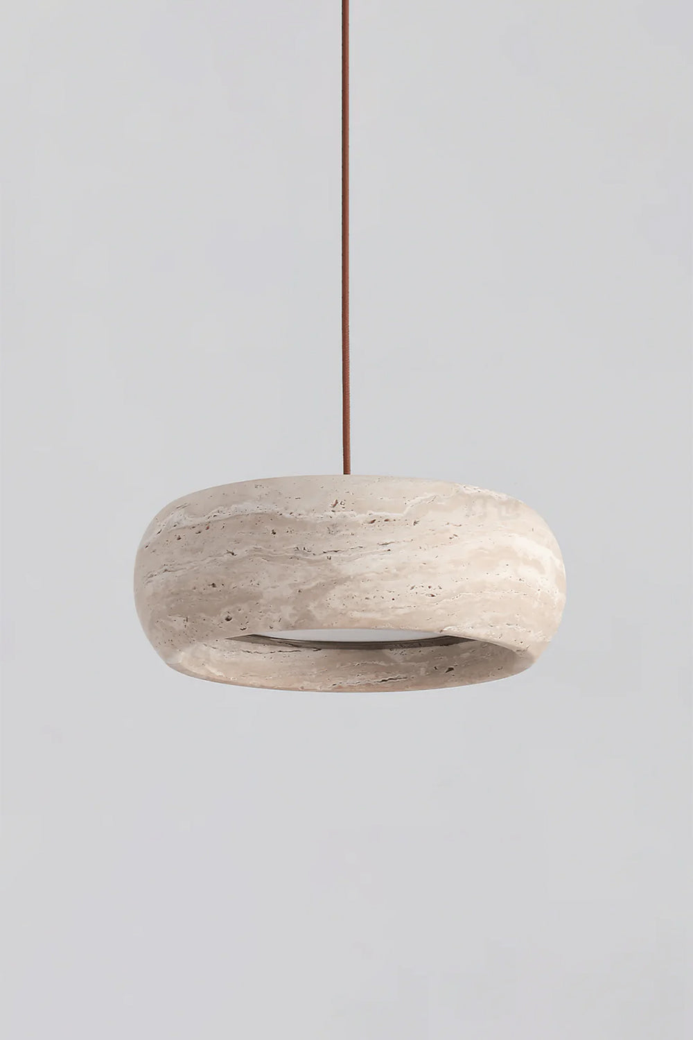 Maro Travertine Donut Pendant Light | Travertine, Metal | Studio front profile view of the unlit organic beige stone donut hanging lamp displayed against a plain grey backdrop | Samu Lamp
