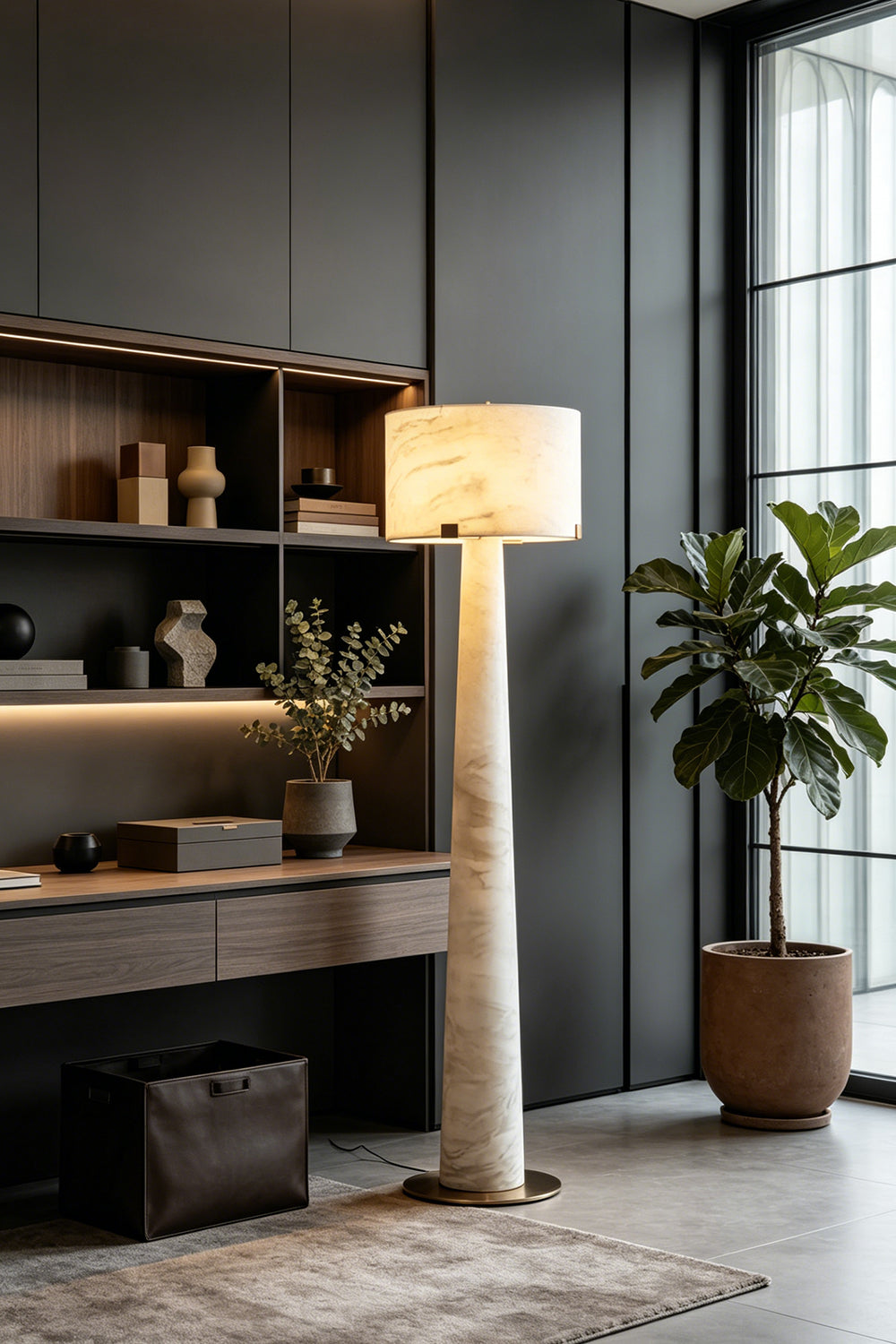 Meridian Column Alabaster Floor Lamp | Alabaster, Brass | Lit in a dark modern home office corner next to a desk | Samu Lamp