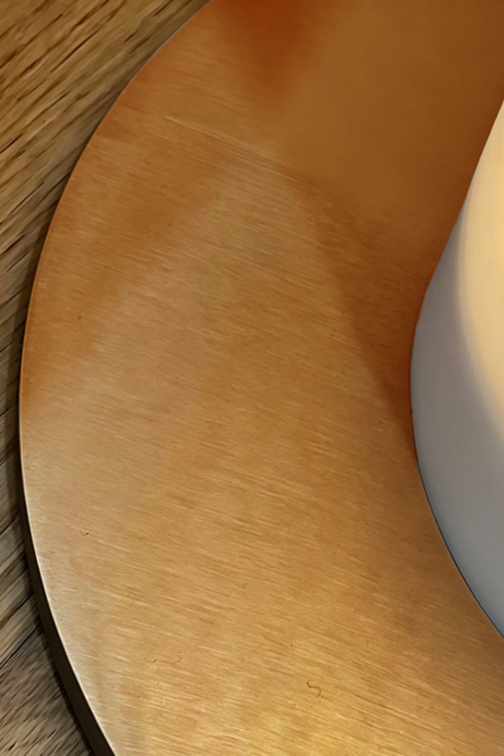 Floor Lamp Detail | Brass | Close-up of the circular brushed brass base on wood surface | Samu Lamp