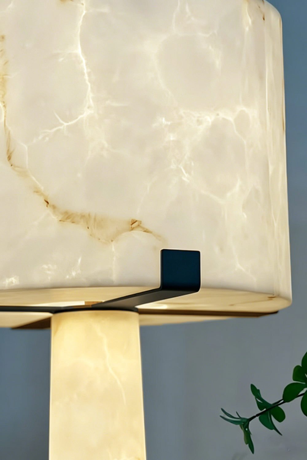 Floor Lamp Detail | Alabaster, Brass | Close-up of lit alabaster shade and brass support clips | Samu Lamp