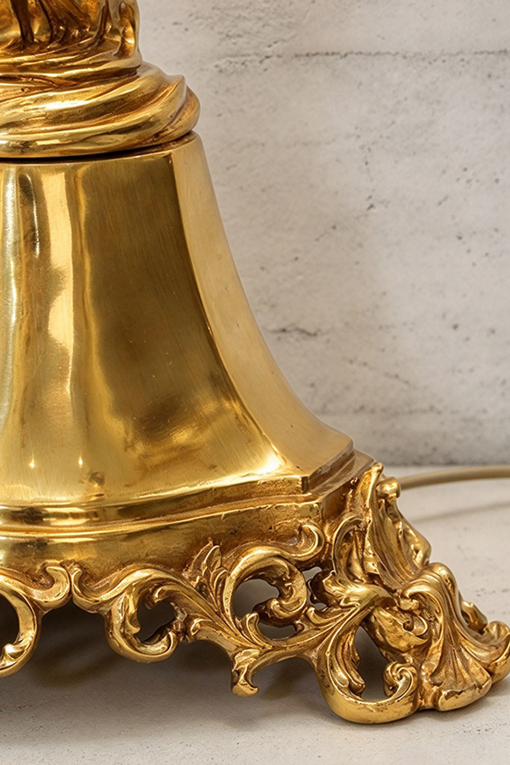 Mervaise Brass Cherub Crystal Tier Table Lamp | Brass and Crystal | Macro detail shot of the intricately carved brass base footings | Samu Lamp