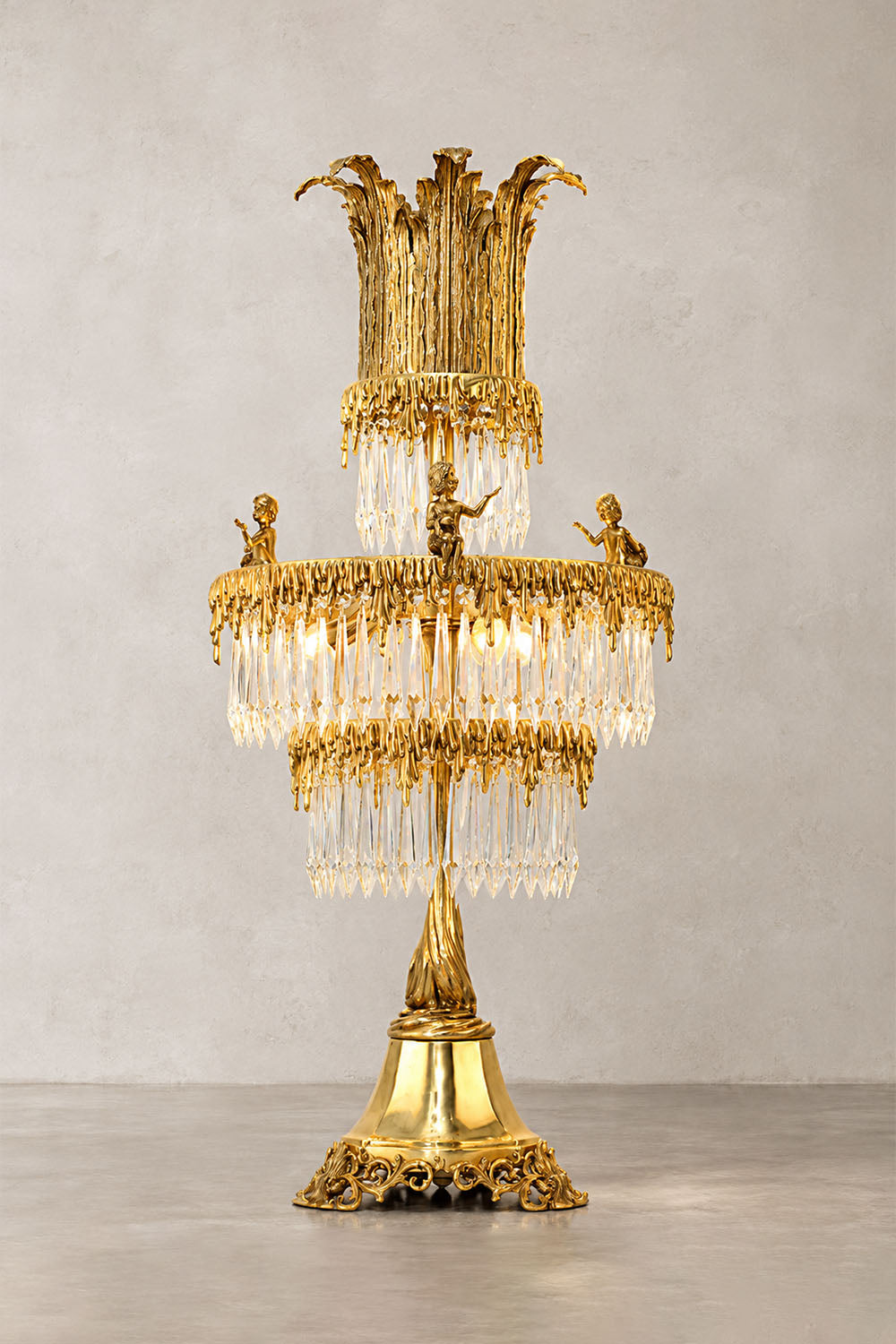 Mervaise Brass Cherub Crystal Tier Table Lamp | Brass and Crystal | Full product view glowing brightly on a plain studio backdrop | Samu Lamp