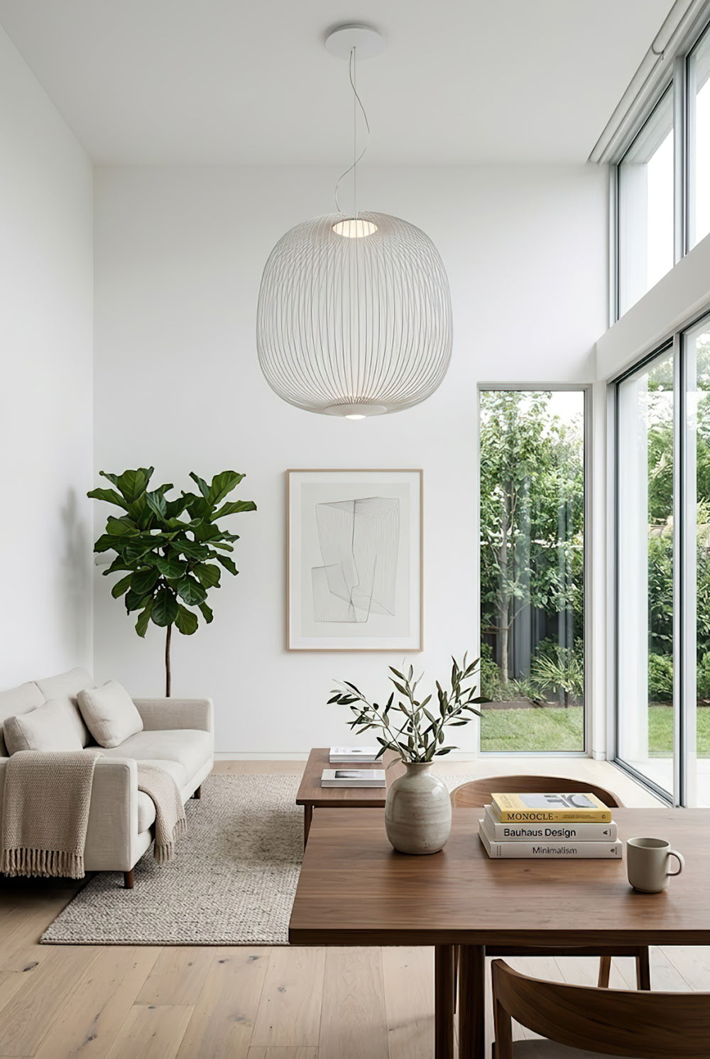 White minimalist wire cage pendant in bright living area | Aluminum | Modern interior scene with neutral decor | Samu Lamp