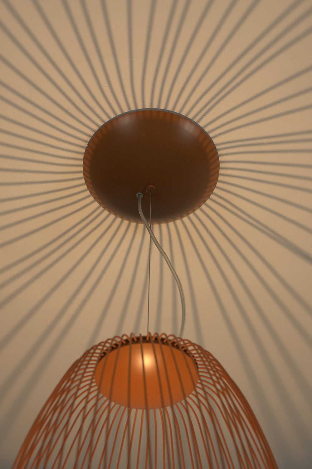 Shadow patterns cast by elliptical wire cage lamp | Aluminum | Artistic ceiling detail with light and shadow | Samu Lamp