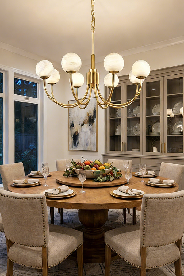 Modern brass and alabaster globe chandelier | Alabaster, Brass | Installed over a round dining table with upholstered chairs | Samu Lamp
