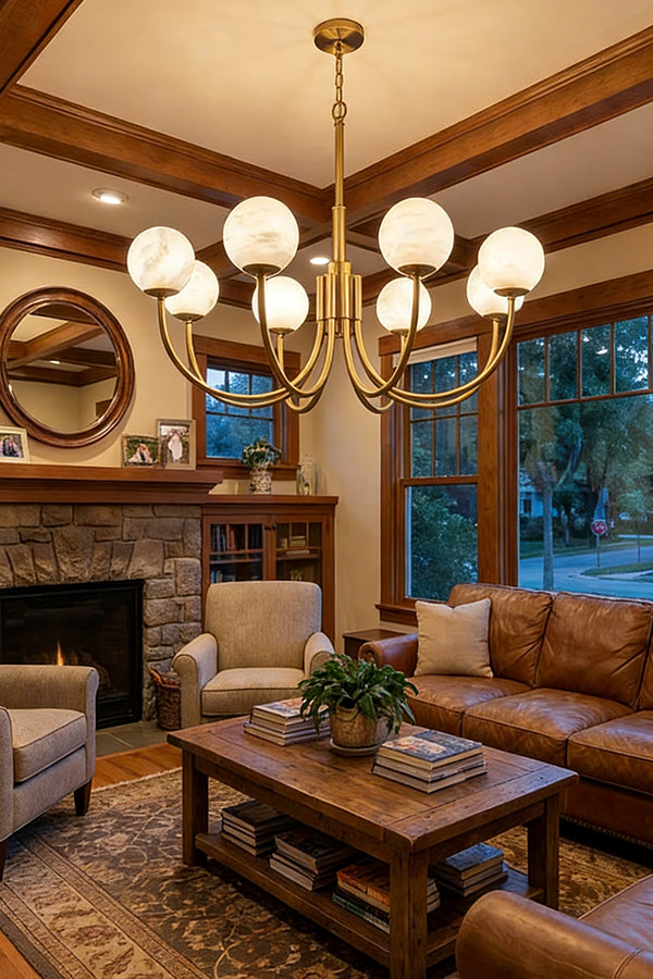 Brass chandelier with alabaster globes | Alabaster, Brass | Installed in a cozy living room with fireplace and leather sofas | Samu Lamp